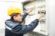 Electrician with drawing at power line box