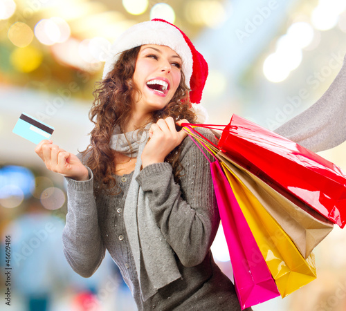 Photo: Christmas Shopping. Girl With Credit Card In Shopping Mall Christmas Shopping. Girl With Credit Card In Shopping Mall