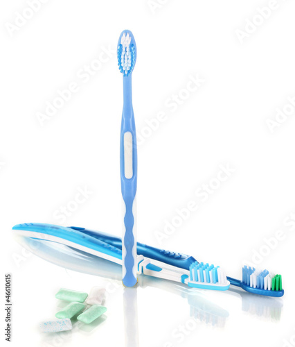 Photo: Toothbrushes and chewing gum isolated on white Toothbrushes and chewing gum isolated on white
