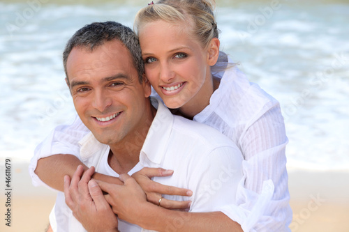 Photo: Couple embracing on the beach Couple embracing on the beach