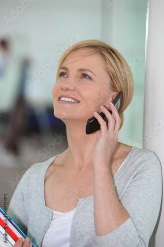 Photo: Happy woman talking on her mobile phone Happy woman talking on her mobile phone
