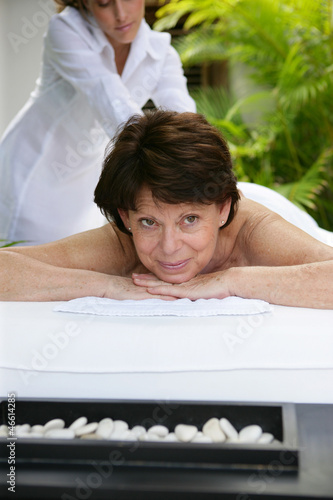 Photo: Woman receiving a massage at a day spa Woman receiving a massage at a day spa