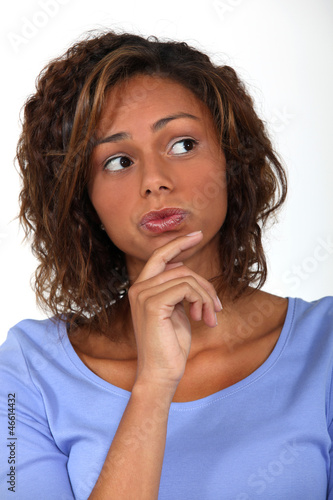 Photo: woman thinking and holding her chin woman thinking and holding her chin