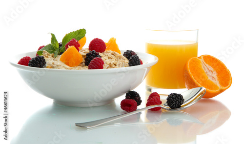 Photo: tasty oatmeal with berries and glass of juice, isolated on tasty oatmeal with berries and glass of juice, isolated on