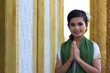 Asian Girl Greets in temple traditional way with both hands