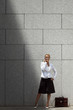 attractive woman speaking on telephone near office building