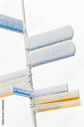 Photo: Dutch street sign in wintertime covered with snow Dutch street sign in wintertime covered with snow