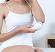 woman scrubbing elbow with scrubber machine