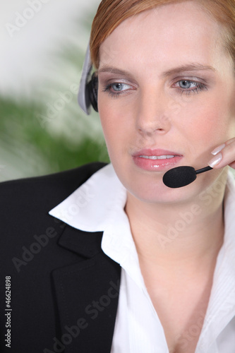 Photo: Receptionist with headphones and microphone Receptionist with headphones and microphone
