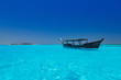 wooden boat in crisp blue water