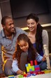 Interracial family at home playing smiling