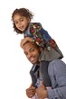 Father and daughter shoulder ride smiling