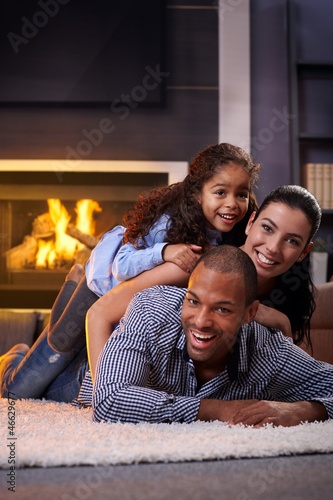 Photo: Happy family having fun at home Happy family having fun at home