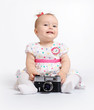 Adorable baby with retro camera over white background