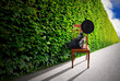 Man puts his feet up in endless hedge - pausing concept