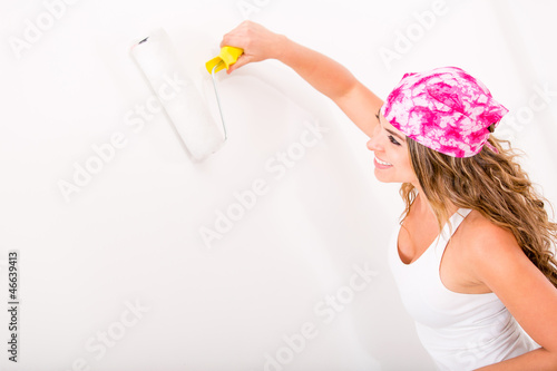 Photo: Woman painting the wall Woman painting the wall