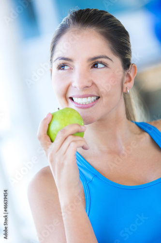 Photo: Woman weating an apple Woman weating an apple