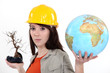 Woman holding a dead bonsai and a globe