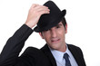 Businessman doffing his hat