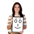Photo: Beautiful brunette girl with a happy face painted on paper Beautiful brunette girl with a happy face painted on paper