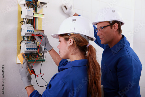 Photo: Man and woman measuring voltage Man and woman measuring voltage