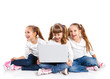 Photo: Three attractive girl using a laptop Three attractive girl using a laptop