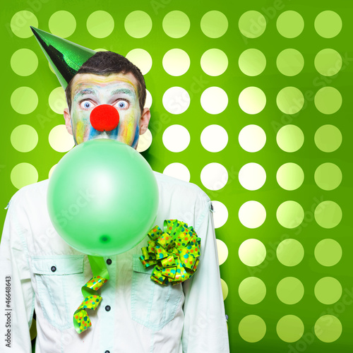Photo: Crazy Party Clown Inflating Green Party Balloon Crazy Party Clown Inflating Green Party Balloon