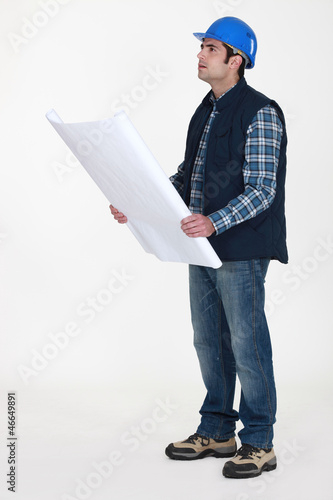 Photo: Tradesman examining a blueprint Tradesman examining a blueprint