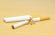 Stop smoking concept with workman sawing cigarettes in half