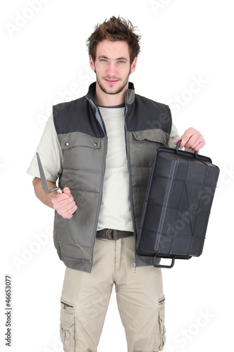 Photo: Tile fitter posing with his building supplies Tile fitter posing with his building supplies