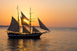 A sailing ship at sunset