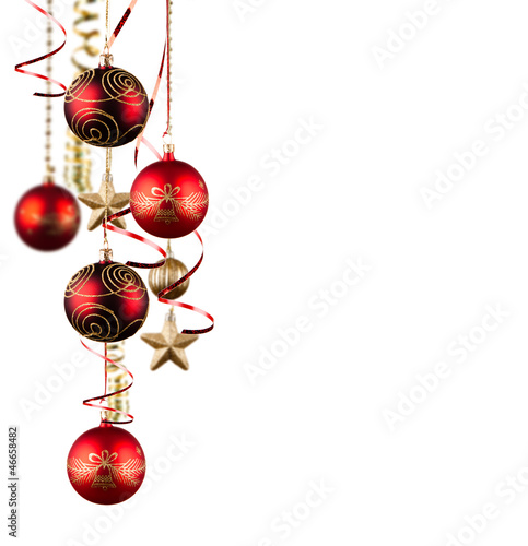 Photo: Bright red Christmas tree balls with curly ribbons isolated on t Bright red Christmas tree balls with curly ribbons isolated on t