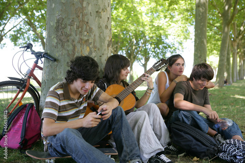 Photo: Group of teenage friends gathered in the park Group of teenage friends gathered in the park