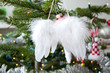white angel-wings hanging in a christmas tree
