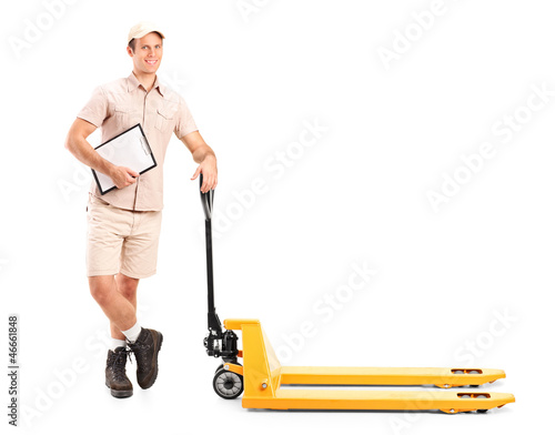 Photo: Manual worker holding a clipboard and fork pallet truck Manual worker holding a clipboard and fork pallet truck