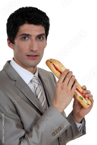 Photo: Businessman eating a sandwich Businessman eating a sandwich