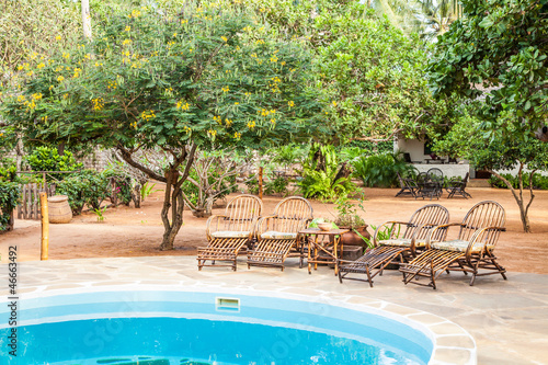 Photo: Chairs on swimming pool border Chairs on swimming pool border