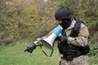 A policeman shouts orders into a megaphone