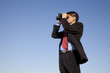 Photo: Businessman searching with his binoculars Businessman searching with his binoculars