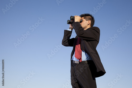 Photo: Businessman searching with his binoculars Businessman searching with his binoculars