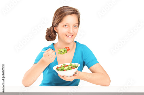 Photo: A smiling girl eating salad A smiling girl eating salad