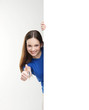 A young brunette teenage girl holding a large white banner