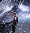 A young redhead woman posing on a snowy blue silk background