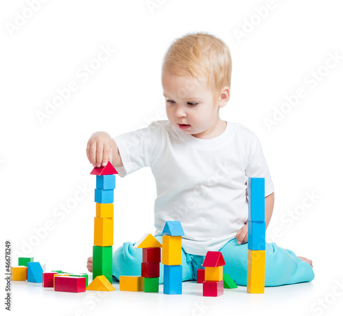 Photo: kid playing toy blocks isolated on white background kid playing toy blocks isolated on white background