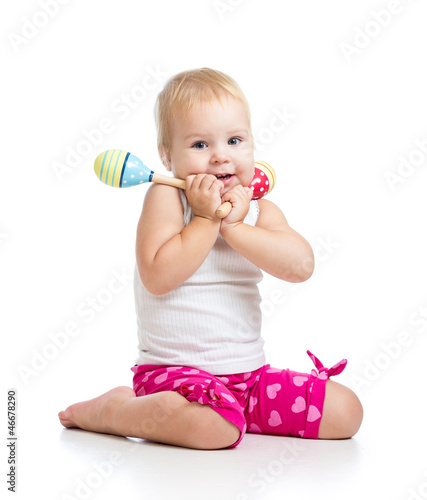 Photo: Kid playing with musical toys. Isolated on white background Kid playing with musical toys. Isolated on white background