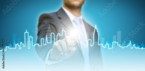 Photo: Businessman building a city concept Businessman building a city concept