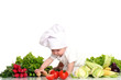 Baby cook with fresh vegetables on a white