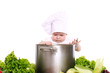 Baby cook with pan and vegetables on a white