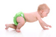 Cute little baby in green diapers in motion