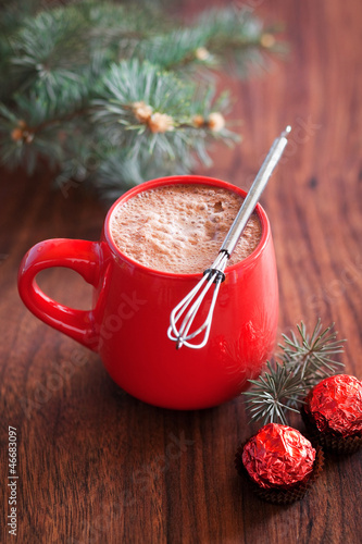 Photo: Hot cocoa in mug and chocolates. Selective focus Hot cocoa in mug and chocolates. Selective focus